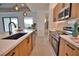 Modern kitchen featuring stainless steel appliances, quartz countertops, and wood grain cabinets at 350 Bucknell Rd, Venice, FL 34293