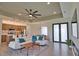 Open-concept living room and kitchen featuring modern decor and expansive glass doors at 350 Bucknell Rd, Venice, FL 34293