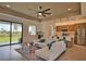 Open-concept living room and kitchen with sleek countertops, stainless steel appliances, and expansive windows at 350 Bucknell Rd, Venice, FL 34293