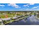 Aerial view of canal-front homes boasting private docks, screened enclosures, and meticulously maintained landscaping at 3615 Tripoli Blvd, Punta Gorda, FL 33950