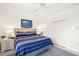 Cozy bedroom with blue striped bed, white nightstands, and ample closet space at 3615 Tripoli Blvd, Punta Gorda, FL 33950