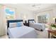 Bright bedroom with two twin beds, large windows, and lanai access offering backyard views at 3615 Tripoli Blvd, Punta Gorda, FL 33950