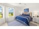 Bright bedroom featuring a large window and a comfortable blue striped bed at 3615 Tripoli Blvd, Punta Gorda, FL 33950