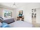 Well-lit bedroom with two twin beds features a sliding door with access to the lanai and backyard at 3615 Tripoli Blvd, Punta Gorda, FL 33950