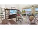 Cozy living room with entertainment center and sliding glass doors to the outdoor lounge area at 3615 Tripoli Blvd, Punta Gorda, FL 33950