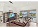 Living room with stylish entertainment center, and sliding glass doors leading to the pool area at 3615 Tripoli Blvd, Punta Gorda, FL 33950