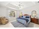 Serene main bedroom with tray ceilings and picturesque water view through a large arched window at 3615 Tripoli Blvd, Punta Gorda, FL 33950