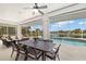 Waterfront patio with screened enclosure, outdoor dining set, and beautiful views at 3615 Tripoli Blvd, Punta Gorda, FL 33950