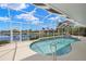 Sparkling waterfront pool and spa with a screened enclosure and serene water views at 3615 Tripoli Blvd, Punta Gorda, FL 33950