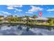 Waterfront home featuring lush landscaping, private docks, and beautiful reflections on the calm canal at 3615 Tripoli Blvd, Punta Gorda, FL 33950