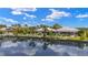 Waterfront home featuring lush landscaping, private docks, and beautiful reflections on the calm canal at 3615 Tripoli Blvd, Punta Gorda, FL 33950