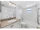 All-white bathroom with granite countertops, tiled walls, and a shower-tub combination at 3640 Ironwood Cir # 302N, Bradenton, FL 34209