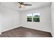 Bedroom with wood floors, ceiling fan, and a window overlooking trees at 3640 Ironwood Cir # 302N, Bradenton, FL 34209