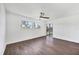 Bright bedroom with wood-look flooring, ceiling fan, and views of the exterior at 3640 Ironwood Cir # 302N, Bradenton, FL 34209