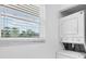 Bright laundry room with stackable washer and dryer next to a window with white blinds at 3640 Ironwood Cir # 302N, Bradenton, FL 34209