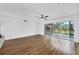 Empty living room with a ceiling fan, hardwood floors, and sliding glass doors at 3640 Ironwood Cir # 302N, Bradenton, FL 34209