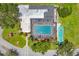 Overhead shot of community pool with a screened enclosure, lounge chairs, and a shuffleboard court at 3640 Ironwood Cir # 302N, Bradenton, FL 34209