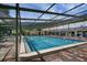 Bright and inviting community pool with screened enclosure and ample lounge seating around the deck at 3640 Ironwood Cir # 302N, Bradenton, FL 34209