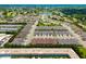 A bird's-eye view of the community, highlighting the pool, townhomes, and location near a scenic lake at 3673 Fescue Ln, Sarasota, FL 34232