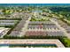 A bird's-eye view of the community, highlighting the pool, townhomes, and location near a scenic lake at 3673 Fescue Ln, Sarasota, FL 34232