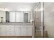 Elegant bathroom featuring dual sinks, granite countertops, a glass shower, and modern fixtures at 3673 Fescue Ln, Sarasota, FL 34232