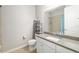 Bright bathroom featuring neutral paint, single sink vanity, and shower with blue curtain at 3673 Fescue Ln, Sarasota, FL 34232