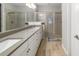 Bathroom featuring a double vanity with stone countertop and glass enclosed shower with tile surround at 3673 Fescue Ln, Sarasota, FL 34232