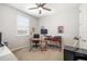 Bedroom featuring a window, ceiling fan, and dedicated desk space at 3673 Fescue Ln, Sarasota, FL 34232