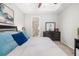 Comfortable bedroom with neutral tones, a ceiling fan, and views into the ensuite bathroom at 3673 Fescue Ln, Sarasota, FL 34232
