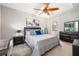 Cozy bedroom featuring a tray ceiling, ceiling fan, and ample natural light at 3673 Fescue Ln, Sarasota, FL 34232