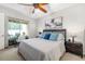 Bright bedroom featuring a ceiling fan and sliding glass doors leading to outdoor space at 3673 Fescue Ln, Sarasota, FL 34232