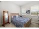 Bright bedroom featuring a blue patterned bed, neutral paint and carpet, and natural lighting at 3673 Fescue Ln, Sarasota, FL 34232