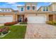 Charming townhome with a brick driveway, freshly cut lawn, and well-kept landscaping at 3673 Fescue Ln, Sarasota, FL 34232