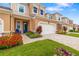 Inviting townhome with a brick driveway, blue accent chair, and well-manicured landscaping at 3673 Fescue Ln, Sarasota, FL 34232