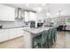 Bright kitchen featuring stainless steel appliances, large island, and modern pendant lighting at 3673 Fescue Ln, Sarasota, FL 34232