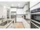 Modern kitchen with stainless steel appliances, white cabinets, and ample counter space at 3673 Fescue Ln, Sarasota, FL 34232