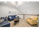 Comfortable living room featuring neutral carpeting, vaulted ceiling, and bright natural light at 3673 Fescue Ln, Sarasota, FL 34232