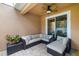 Covered patio with comfortable wicker furniture, a ceiling fan, and lush, colorful potted plants at 3673 Fescue Ln, Sarasota, FL 34232