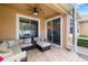 Relaxing screened-in patio with wicker furniture and a ceiling fan for comfortable outdoor living at 3673 Fescue Ln, Sarasota, FL 34232