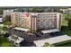 Aerial view showcasing the condo building with covered parking, lush landscaping, and well-maintained grounds at 3680 Ironwood Cir # 603L, Bradenton, FL 34209