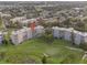 Aerial view of condo complex on a lush golf course with mature trees and ponds at 3680 Ironwood Cir # 603L, Bradenton, FL 34209