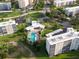 Aerial view of a condo complex featuring a pool, sun deck, and well-manicured lawns, offering luxurious amenities at 3680 Ironwood Cir # 603L, Bradenton, FL 34209