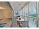 Cozy balcony features tiled floor, shutters and a charming table with seating for enjoying the views at 3680 Ironwood Cir # 603L, Bradenton, FL 34209