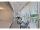 Inviting balcony with white shutters, tile flooring, and comfortable seating, perfect for relaxing and enjoying the view at 3680 Ironwood Cir # 603L, Bradenton, FL 34209