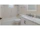 Classic bathroom featuring marble counters, shower with tub, and bright window at 3680 Ironwood Cir # 603L, Bradenton, FL 34209