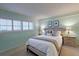 Cozy bedroom features a plush bed, side tables, and bright light from the shuttered windows at 3680 Ironwood Cir # 603L, Bradenton, FL 34209