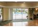 View of the pool from the clubhouse at this residence with large sliders and beautiful flooring at 3680 Ironwood Cir # 603L, Bradenton, FL 34209