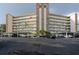 Condo building featuring balconies, covered parking, manicured landscaping, and a stone accent center at 3680 Ironwood Cir # 603L, Bradenton, FL 34209