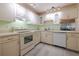 Bright kitchen featuring white cabinets, modern appliances, and neutral countertops with a view at 3680 Ironwood Cir # 603L, Bradenton, FL 34209