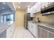 Modern clubhouse kitchenette featuring updated appliances, sink, and countertops at 3680 Ironwood Cir # 603L, Bradenton, FL 34209